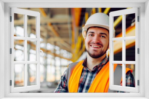 Engineer or civil worker in helmet smiling inside a construction building