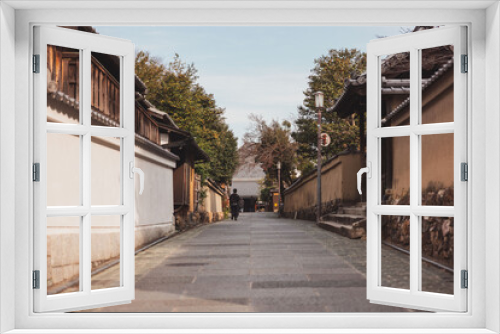 Fototapeta Naklejka Na Ścianę Okno 3D - Man walking down street in Kyoto