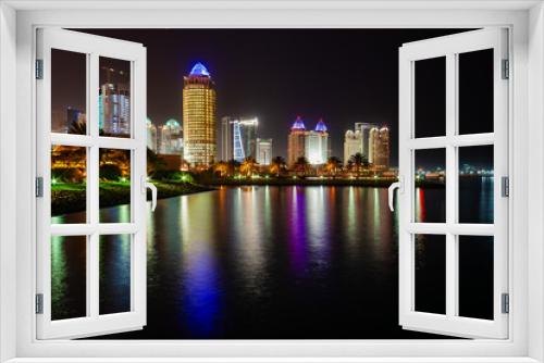 Fototapeta Naklejka Na Ścianę Okno 3D - A view of Doha skyscrapers at night