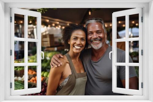 Portrait of smiling couple buying fruits and vegetables at farmers market.