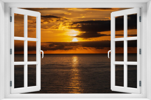 Fototapeta Naklejka Na Ścianę Okno 3D - Calm sea with sunset sky and sun through the clouds over. Meditation ocean and sky background. Tranquil seascape. Horizon over the water