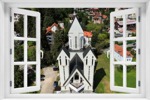 Aerial view showcasing the architectural features of the St. Constantine and Elena Orthodox Church, located in the center of the town of Predeal in Romania.