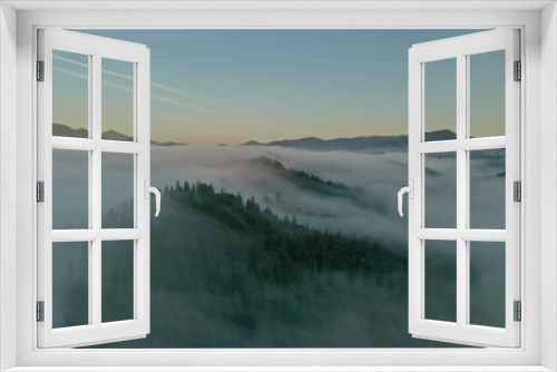 Fototapeta Naklejka Na Ścianę Okno 3D - Aerial view of beautiful mountains and conifer trees on foggy morning