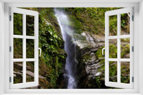 Fototapeta Naklejka Na Ścianę Okno 3D - waterfall flowing through rock surrounded by green moss walls