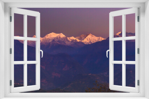 Fototapeta Naklejka Na Ścianę Okno 3D - A view of Snow clad Kangchenjunga, also spelled Kanchenjunga,the third highest mountain in the world, at the time of Sunrise.