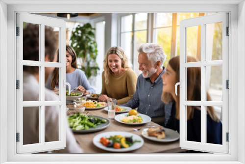 Happy multi-generation family enjoying in a lunch together at home.