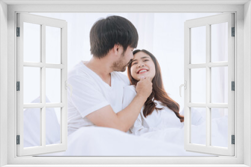 Happy love Asian young man and woman staying together in bedroom, Valentine's Day, Concept of holiday and surprise.