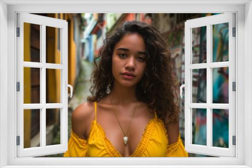 Serene woman in a yellow off-shoulder top, with a charming alley and graffiti as a colorful backdrop.