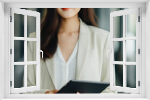 Portrait of young asian business woman using digital tablet in modern office