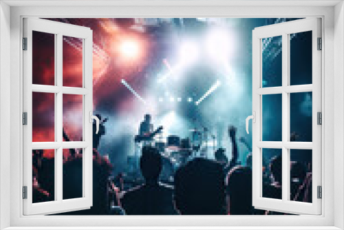 Concert crowd in front of a bright stage lights, music festival