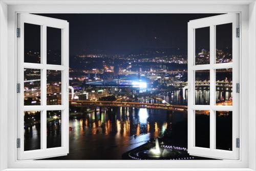 Fototapeta Naklejka Na Ścianę Okno 3D - Downtown at night. View of the city lights and landscape. Panoramic view of the bridge and river in the downtown city of Pittsburgh, Pennsylvania —aerial, birds' eye view of downtown and river.