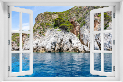 Fototapeta Naklejka Na Ścianę Okno 3D - Scenic landscape of Island of Corfu, Greece, western shoreline with cliffs and caves at beach and water line of turquoise or deep blue water with breath taking limestone formations