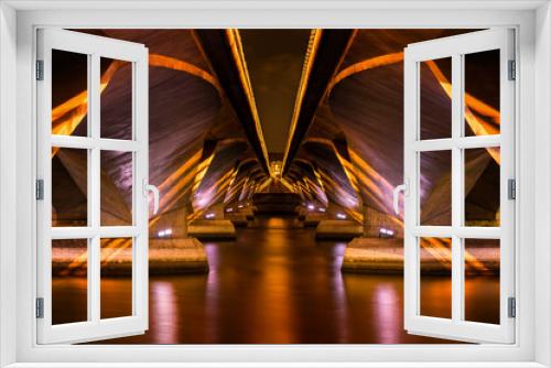 Fototapeta Naklejka Na Ścianę Okno 3D - Golden symmetrical lights under a modern concrete bridge over a river
