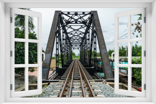 Fototapeta Naklejka Na Ścianę Okno 3D - black steel bridge train across river