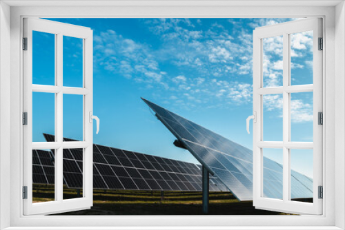 Fototapeta Naklejka Na Ścianę Okno 3D - side of row of solar panels in photovoltaic solar plant, bright sunny day