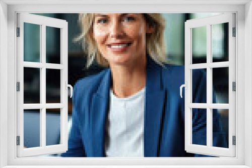 Portrait of smiling businesswoman using laptop at workplace in modern office