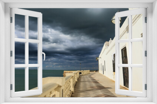 Fototapeta Naklejka Na Ścianę Okno 3D - Houses in the promenade of Chipiona Beach on a stormy day