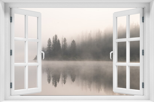 Fototapeta Naklejka Na Ścianę Okno 3D - Forest reflected in misty mountain lake
