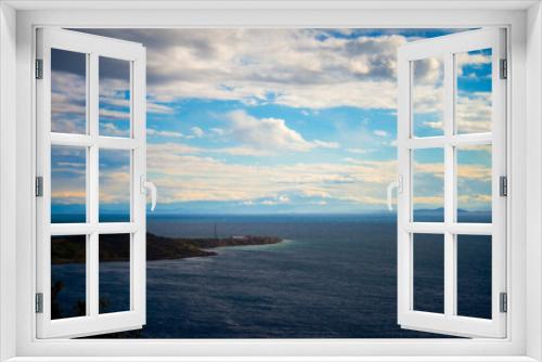 Fototapeta Naklejka Na Ścianę Okno 3D - A serene view of a coastal peninsula, where land meets the sea, creating a picturesque scene of nature's beauty and the tranquil horizon over the water.