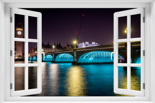 Fototapeta Naklejka Na Ścianę Okno 3D - London. UK- 02.04.2024. A night time long exposure view of Westminster Bridge with Big Ben at the end and light reflections on the River Thames.