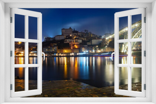 Fototapeta Naklejka Na Ścianę Okno 3D - Panoramic long exposure night view of Porto, Portugal, the Douro River, and Dom Luis Bridge during a rainy night