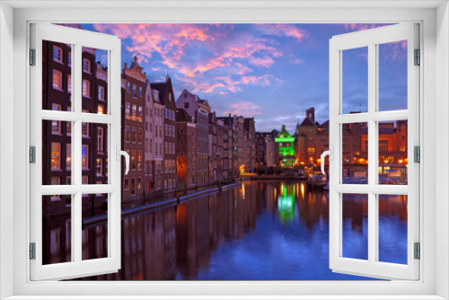 Fototapeta Naklejka Na Ścianę Okno 3D - City scenic from Amsterdam by night in the Netherlands at sunset
