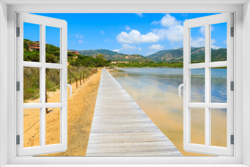 Fototapeta Naklejka Na Ścianę Okno 3D - Wooden walkway to Chia beach along a salt lake, Sardinia island