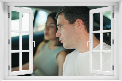 Beautiful couple passengers sitting on car at street