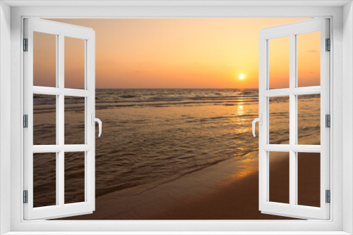 Fototapeta Naklejka Na Ścianę Okno 3D - Sunset over the beachy sea with a beautiful orange-red twilight, and reflections in the water. Sea beach with sunrise or sunset, seascape, Landscape