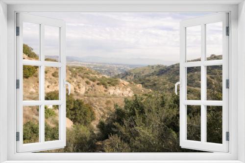 Fototapeta Naklejka Na Ścianę Okno 3D - Rocky Peak with a distant view of Chatsworth in the San Fernando Valley, Los Angeles. Viewed from Simi Valley, Ventura County in Southern California.