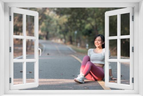 A fit woman enjoys a healthy jog in a park filled with summery green