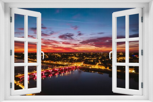 Fototapeta Naklejka Na Ścianę Okno 3D - Golden Hues Envelop Blois: Captivating Sunset Paints City and Bridge in Luminous Tones