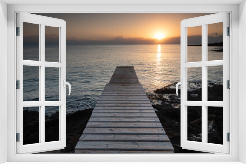 Fototapeta Naklejka Na Ścianę Okno 3D - Long wooden pier in the sea at sunrise.
