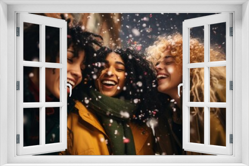 A multiracial group of young happy friends are having fun, celebrating a confetti party in winter during a snowfall.