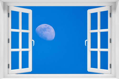 Fototapeta Naklejka Na Ścianę Okno 3D - the moon seen during the day in the blue sky