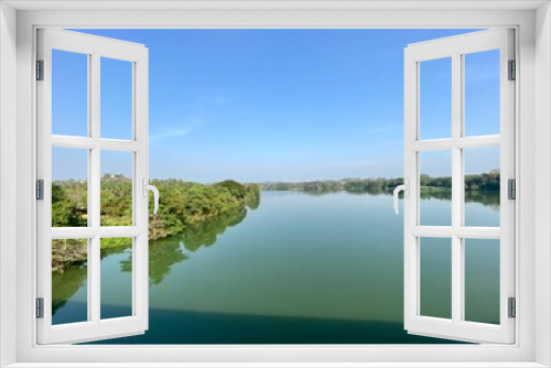 Fototapeta Naklejka Na Ścianę Okno 3D - Wide bed of a river flowing through green forests in the jungles around Sakaleshpura in Karnataka in South India.