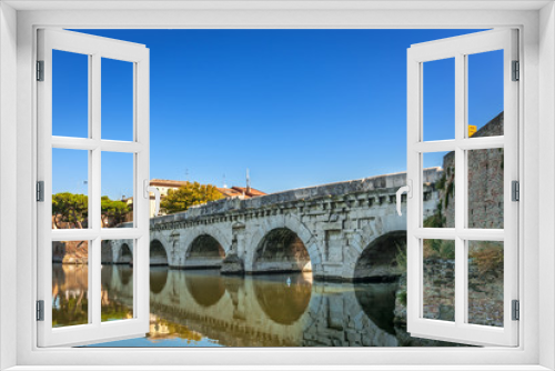 Historical roman Tiberius bridge over Marecchia river in Rimini