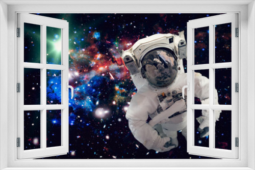 Fototapeta Naklejka Na Ścianę Okno 3D - Astronaut surfing dark space with stars. The elements of this image furnished by NASA.