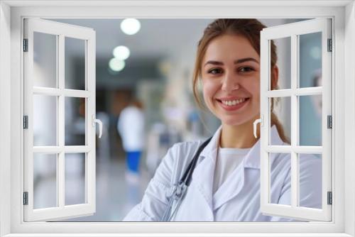 The medic in a white coat smiles, projecting confidence and approachability in the hospital interior.