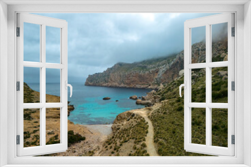 Mallorca, Cala Boquer beach, aerial drone view of torquoise water and rocks in the cloudy day