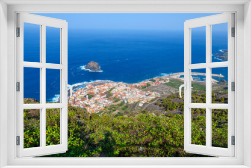 Fototapeta Naklejka Na Ścianę Okno 3D - High angle panoramic view of the seaside town of Garachico, Spain, with it's natural lava pools, historic fort and old town, and volcanic coast on the Canary Island of Tenerife.