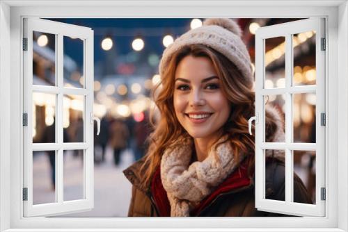 Happy, beautiful, in background blurry New Year's decorated city. Outside on Christmas. New Year's fair on street. Portrait of European woman against festively decorated city during Christmas season