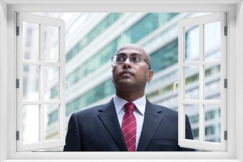 Confident Indian Business man standing in modern city