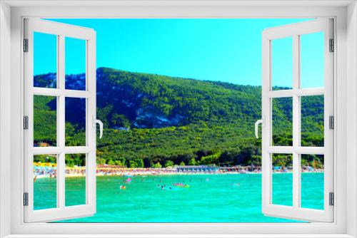 Fototapeta Naklejka Na Ścianę Okno 3D - Relaxing view from Molo Portonovo at the Adriatic Sea and the bright azure hues of its crystalline waters, glowing and scintillating, skimming the white pebble beach with equipment, with mountains