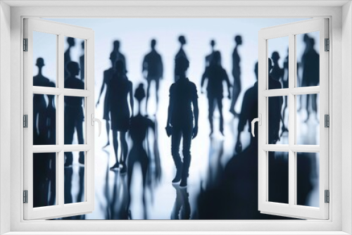 Silhouetted group of people against a blue background. Suitable for various concepts and designs