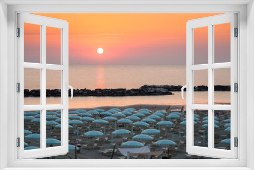 Fototapeta Naklejka Na Ścianę Okno 3D - Beautiful sunrise on Rimini beach with umbrellas