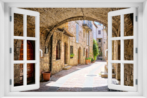 Fototapeta Naklejka Na Ścianę Okno 3D - Beautiful arched street in the medieval old town of Assisi, Umbria, Italy