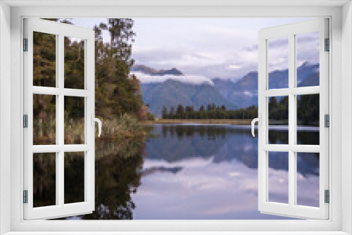 Fototapeta Naklejka Na Ścianę Okno 3D - Beautiful lake surrounded by exotic forest and mountains in background during sunset, New Zealand