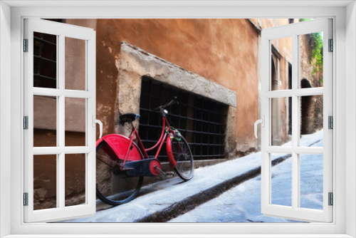 Fototapeta Naklejka Na Ścianę Okno 3D - Red antique bicycle along quaint stone Italian street