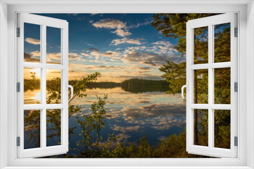 Fototapeta Naklejka Na Ścianę Okno 3D - sunset over lake in Sweden framed by trees